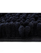 Tapete baño Shaggy Coral gris oscuro 40x60 cm con textura suave y diseño contemporáneo ideal para baño en espacios modernos